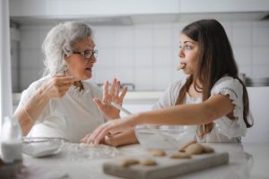 grandma and granddaughter bonding over cooking